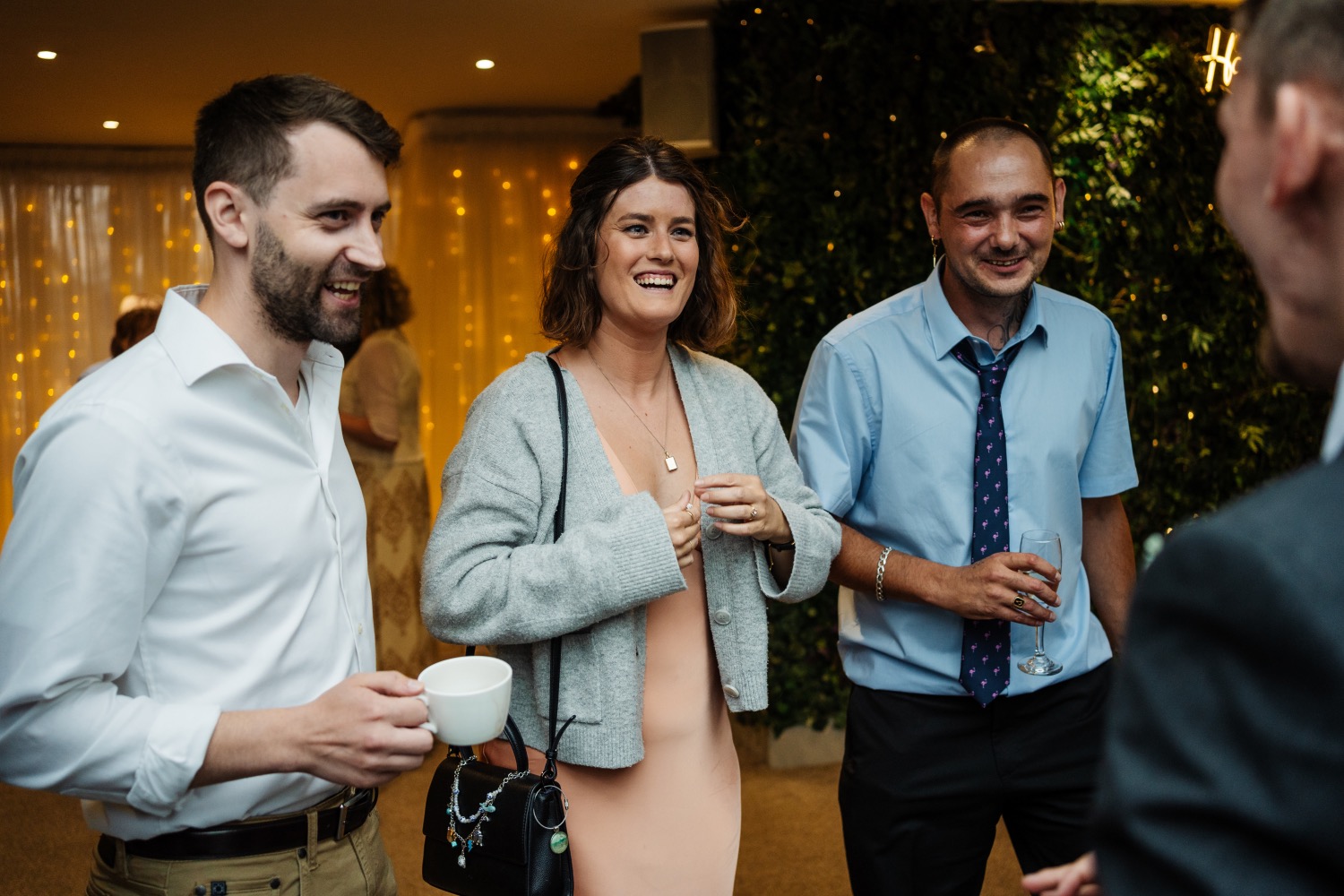 Wedding guests reacting together to close-up magic